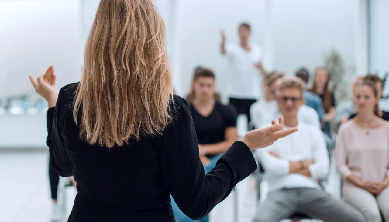 An AI-generated image of a woman addressing an audience.